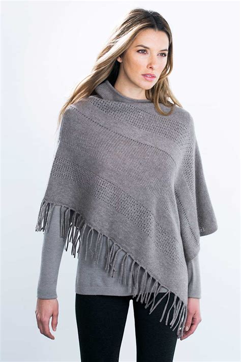 Cashmere and wool poncho with fringing .